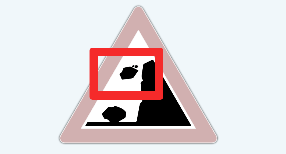 Warning sign of falling rocks that shows rock falling midair